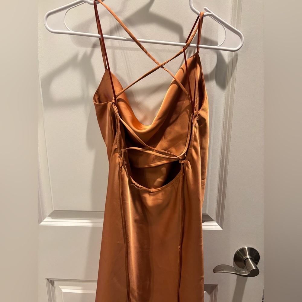 Copper slip dress. Never worn. No tags. Small stain on satin. Size small